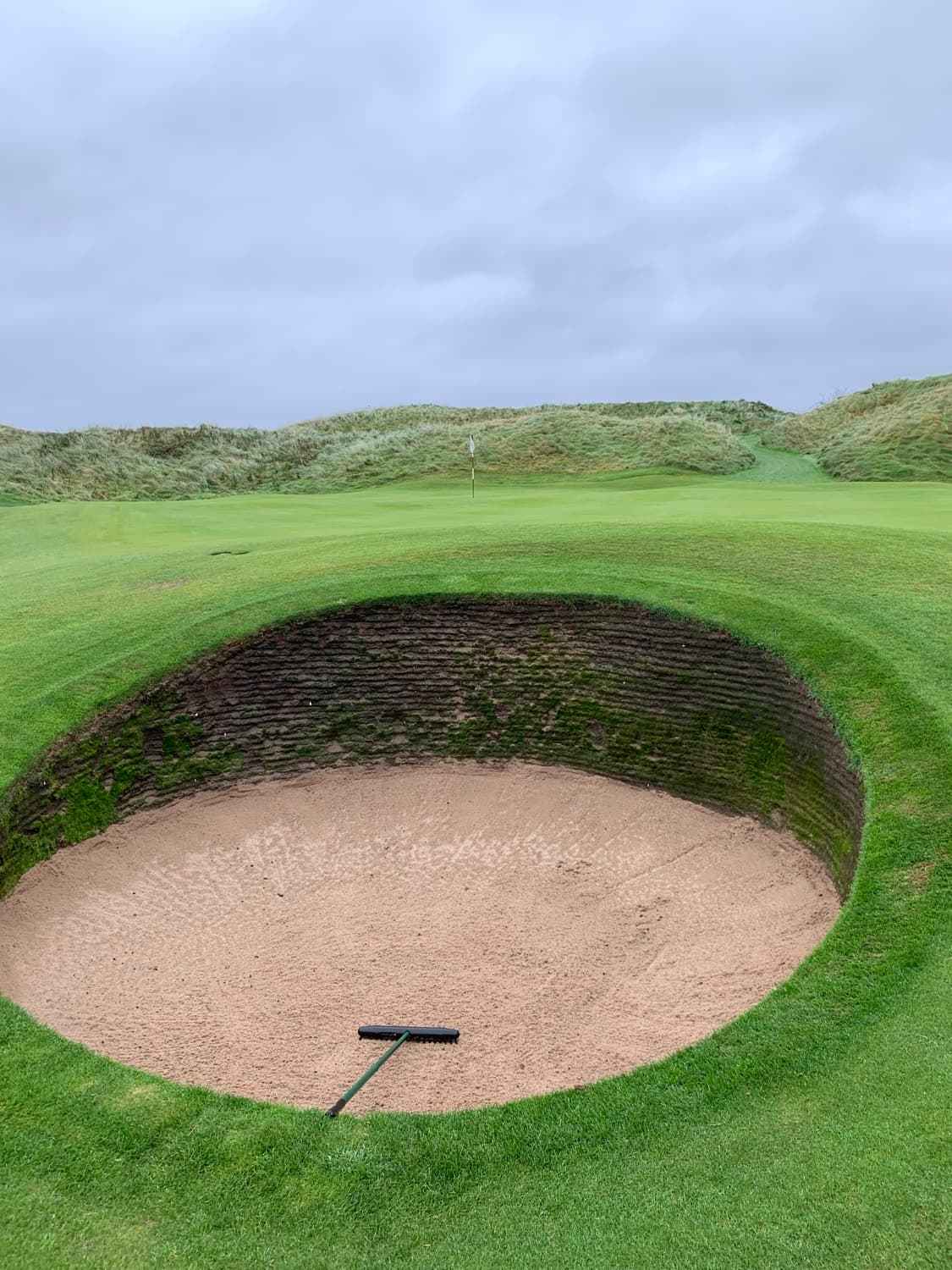 A deep revetted pot bunker on a Scottish links