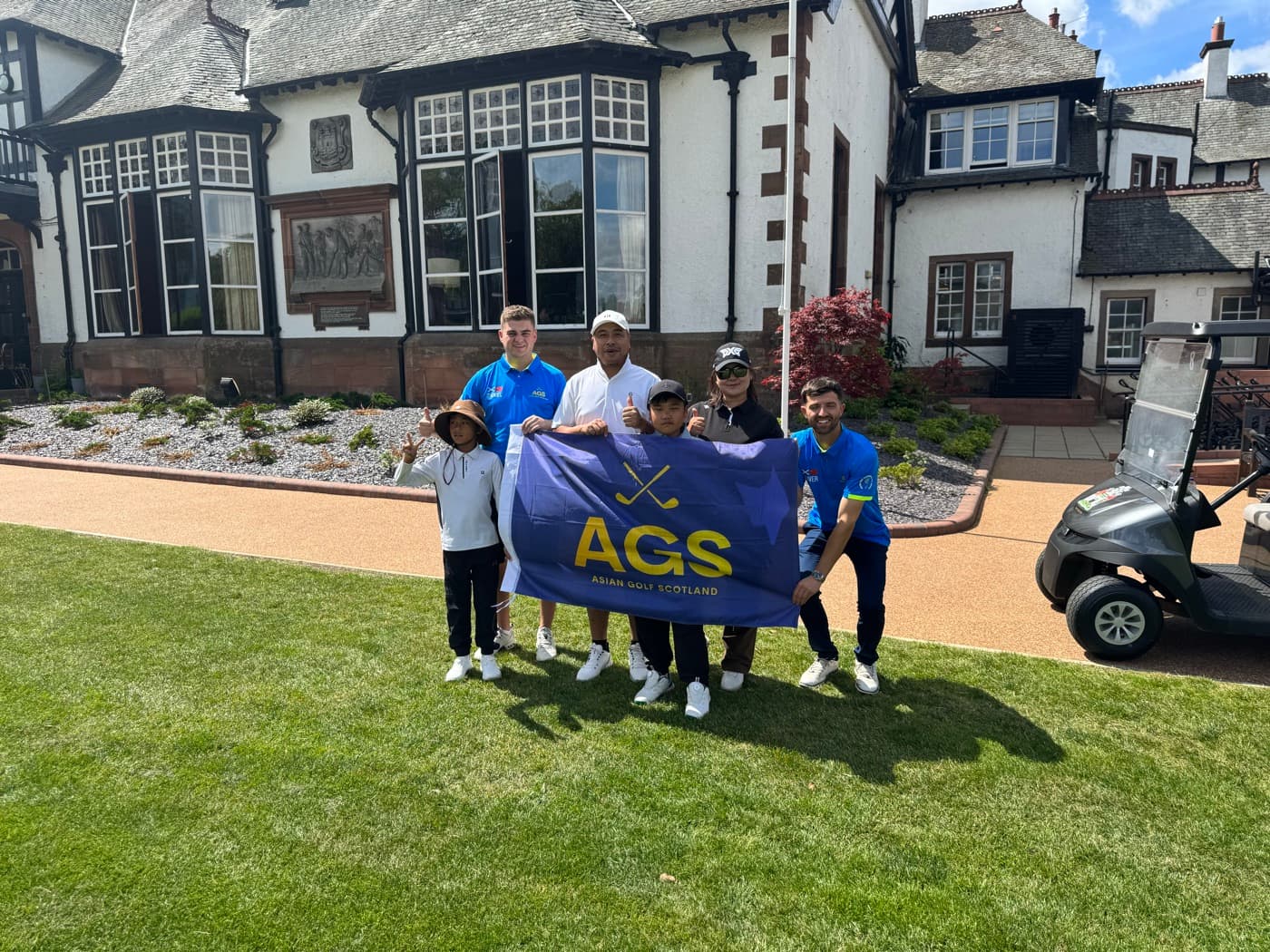 AGS juniors with the flag outside a Scottish clubhouse